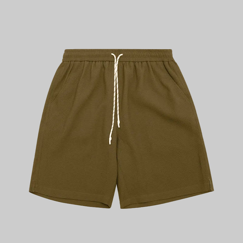 Waffle lounge shorts in moss green, elastic waistband with white drawstring, relaxed fit.
