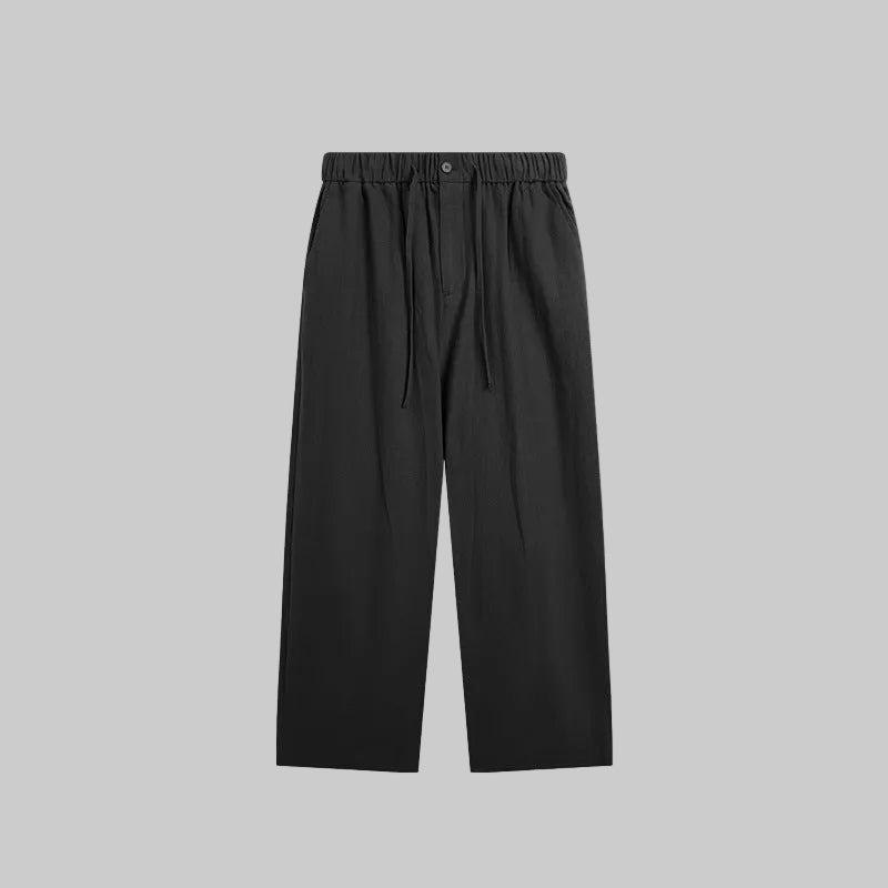 Black linen-blend wide-leg trousers, flat lay with elastic waistband and drawstring