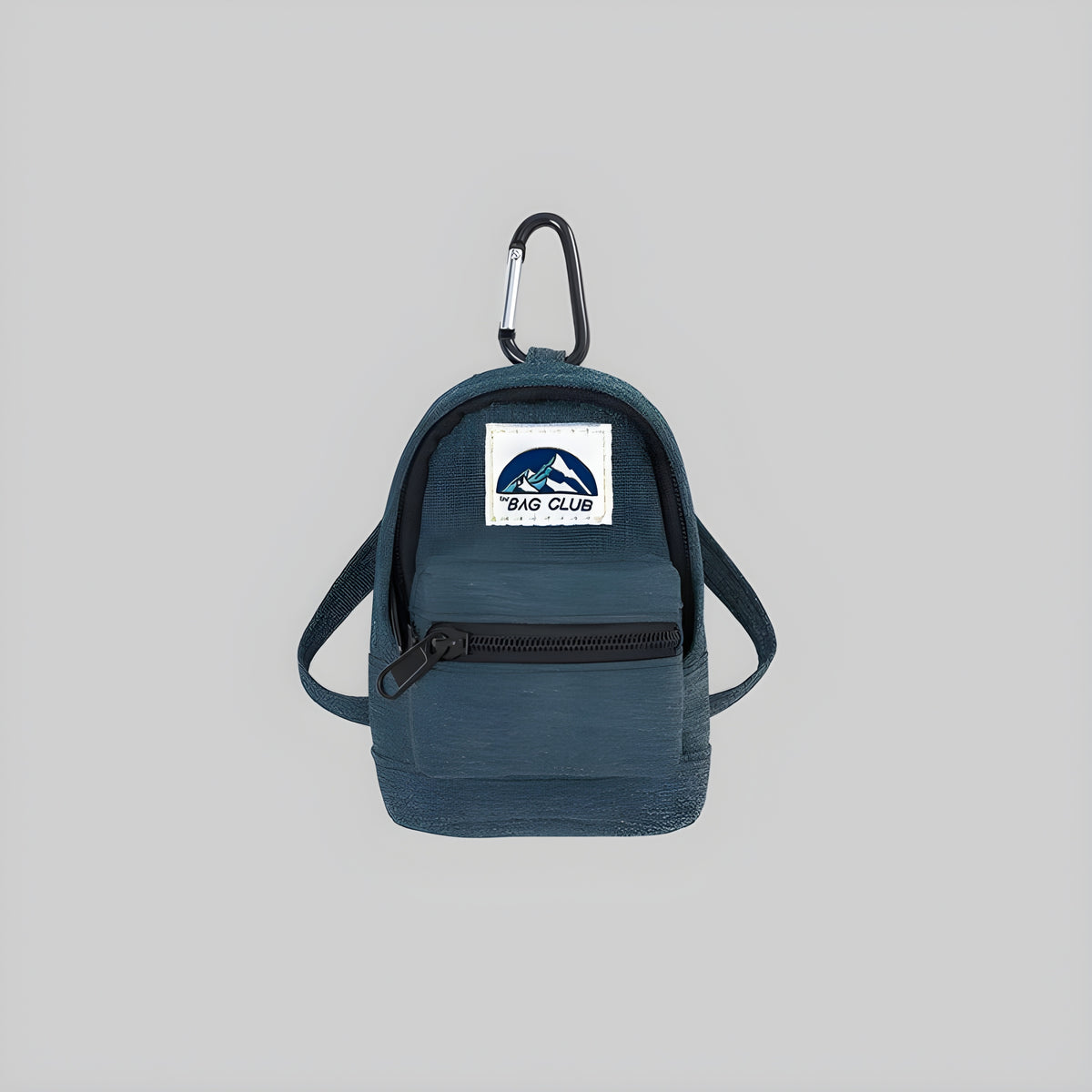 Slate blue mini backpack pouch with top handle, front zip pocket, and BAG CLUB patch