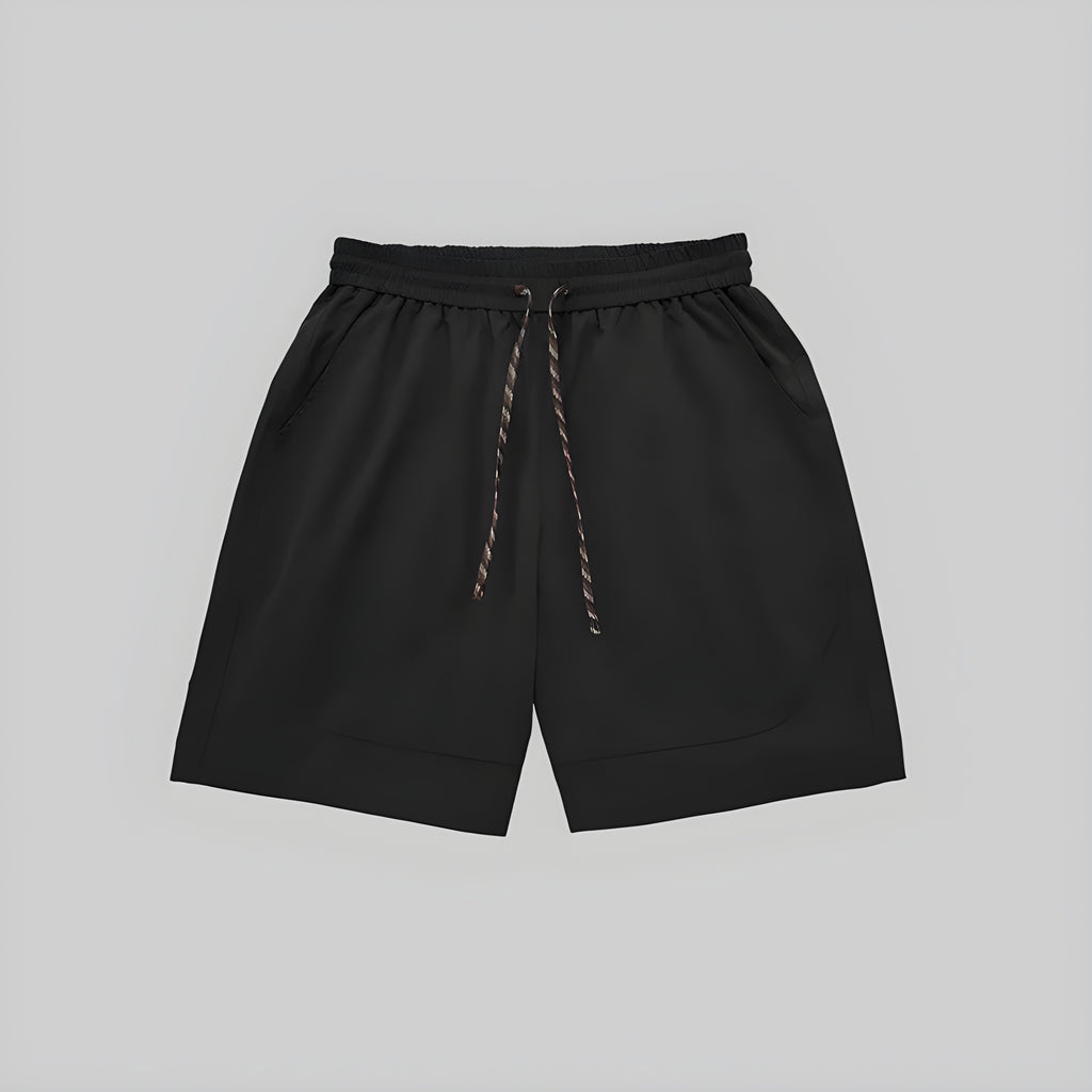 Black technical training shorts with elastic waistband, drawstring, and side pockets.