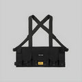 Black cross-strap chest harness with front panel, pockets, and adjustable side ties
