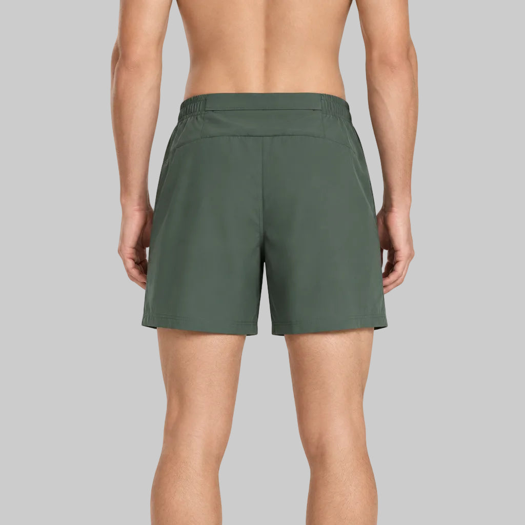 Technical Velocity short in dark olive green, elastic waistband, side slits, relaxed fit.