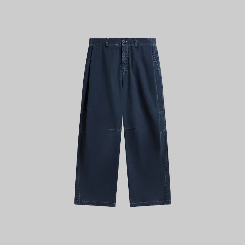 Washed bamboo trousers in medium blue denim, flat front with straight wide legs.