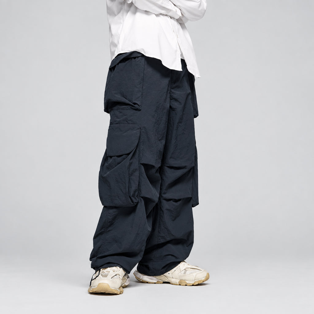 Indigo wide-leg cargo trousers with multiple flap pockets and relaxed fit cuffs