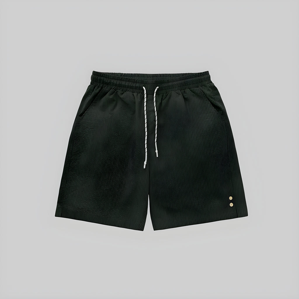 Dark green seersucker shorts with elastic waistband and drawstring; side eyelet details