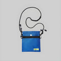 Small bright blue crossbody bag with adjustable strap and front snap button pocket