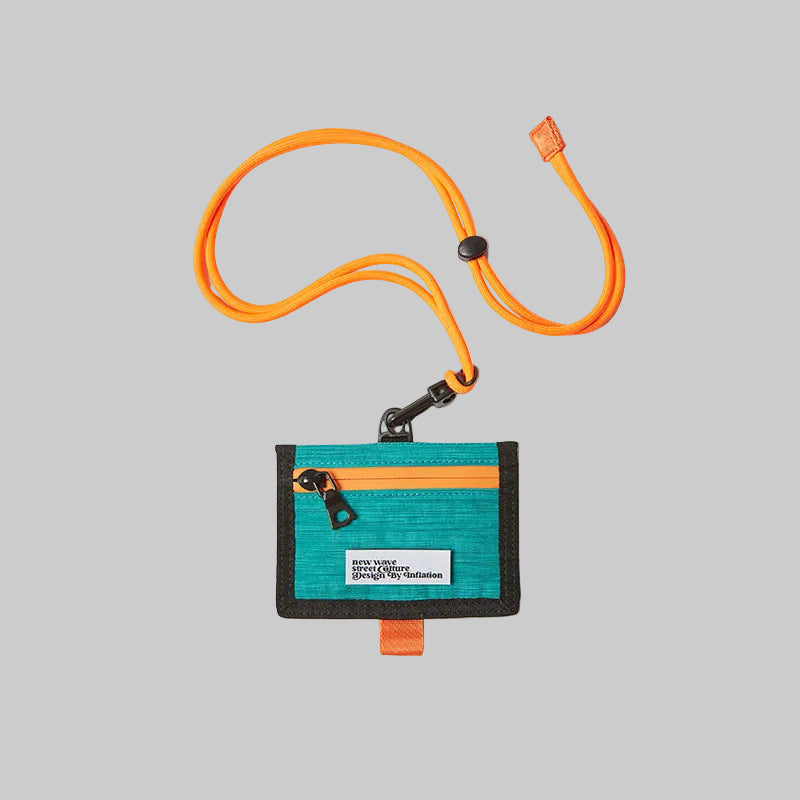 Woven crossbody bag in teal with orange lanyard and zippered front pocket