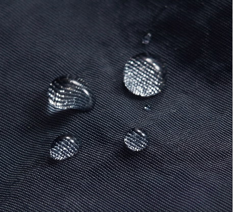 Navy cargo trouser fabric close-up with stitched seams and snap buttons details