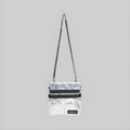 White reflective foldover crossbody bag with long shoulder strap, black stripe, front flap
