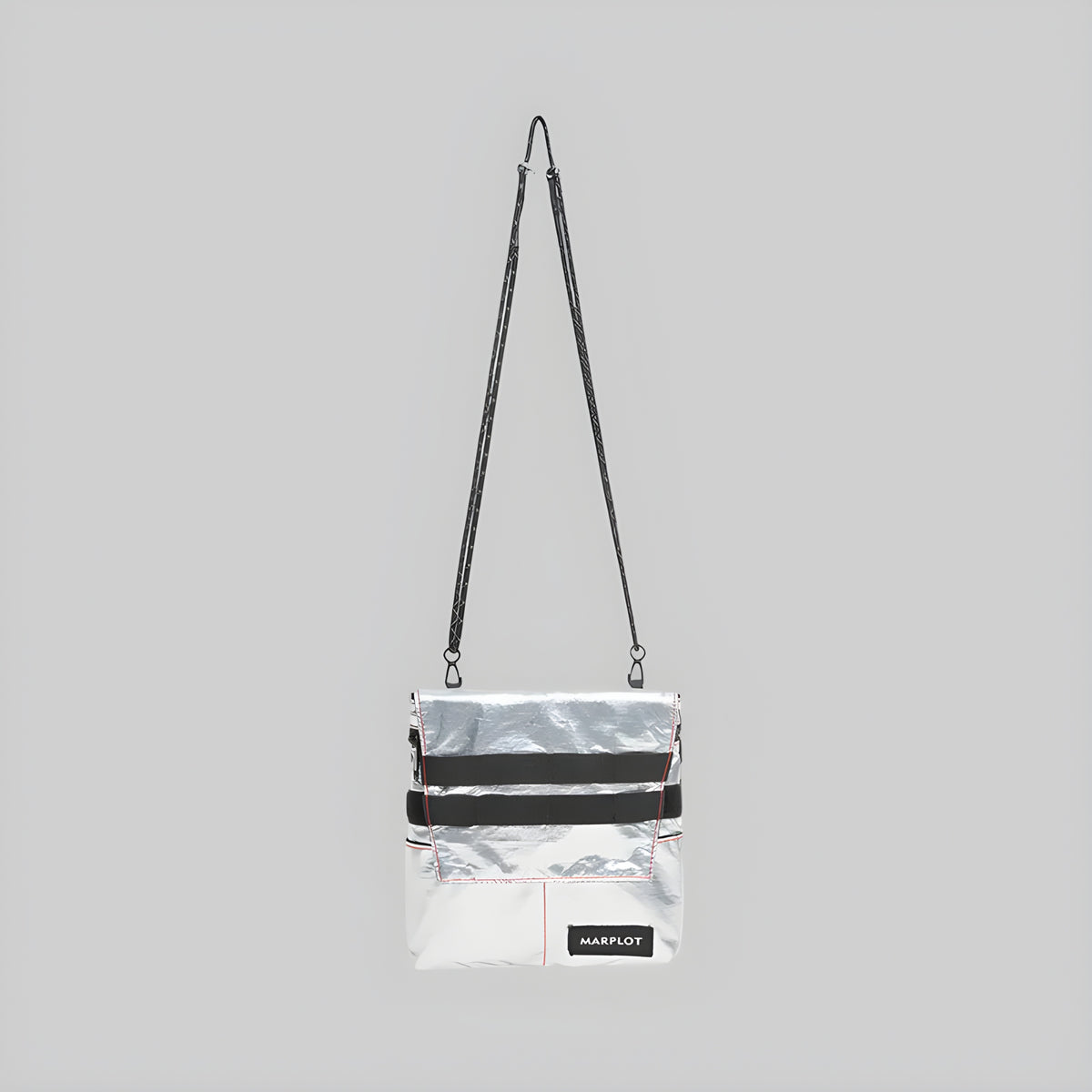 White reflective foldover crossbody bag with long shoulder strap, black stripe, front flap
