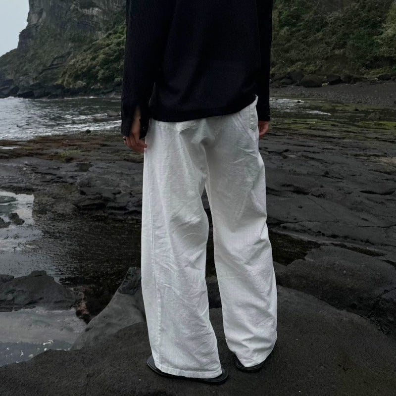 Ivory linen wide-leg trousers with gathered elastic waist and relaxed leg shape