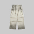 Washed utility trousers in washed khaki, drawstring waist, relaxed wide-leg fit.