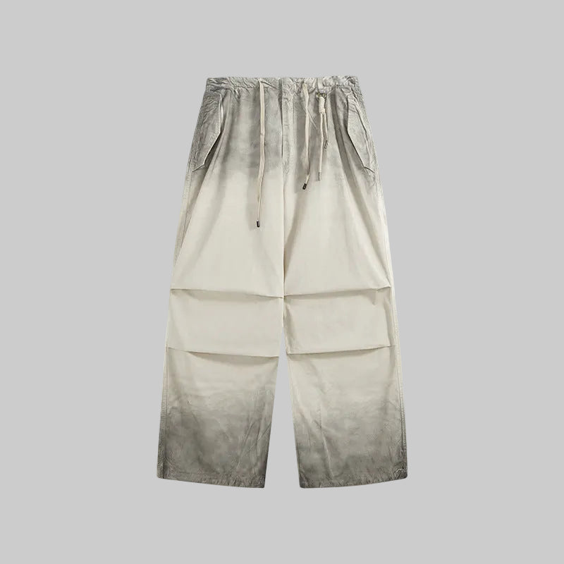 Washed utility trousers in washed khaki, drawstring waist, relaxed wide-leg fit.