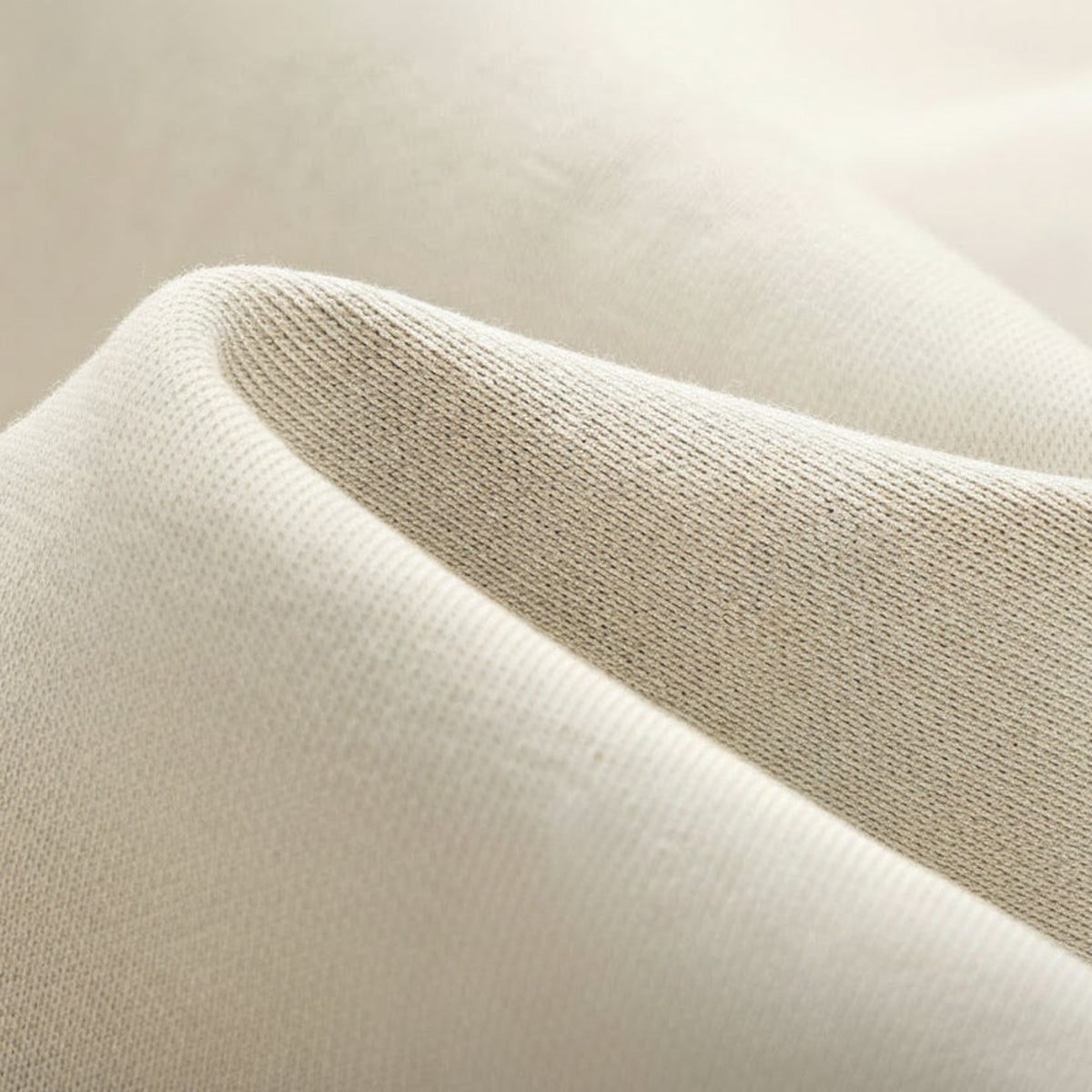 Cream uniform jacket fabric close-up, knit texture with subtle heather effect