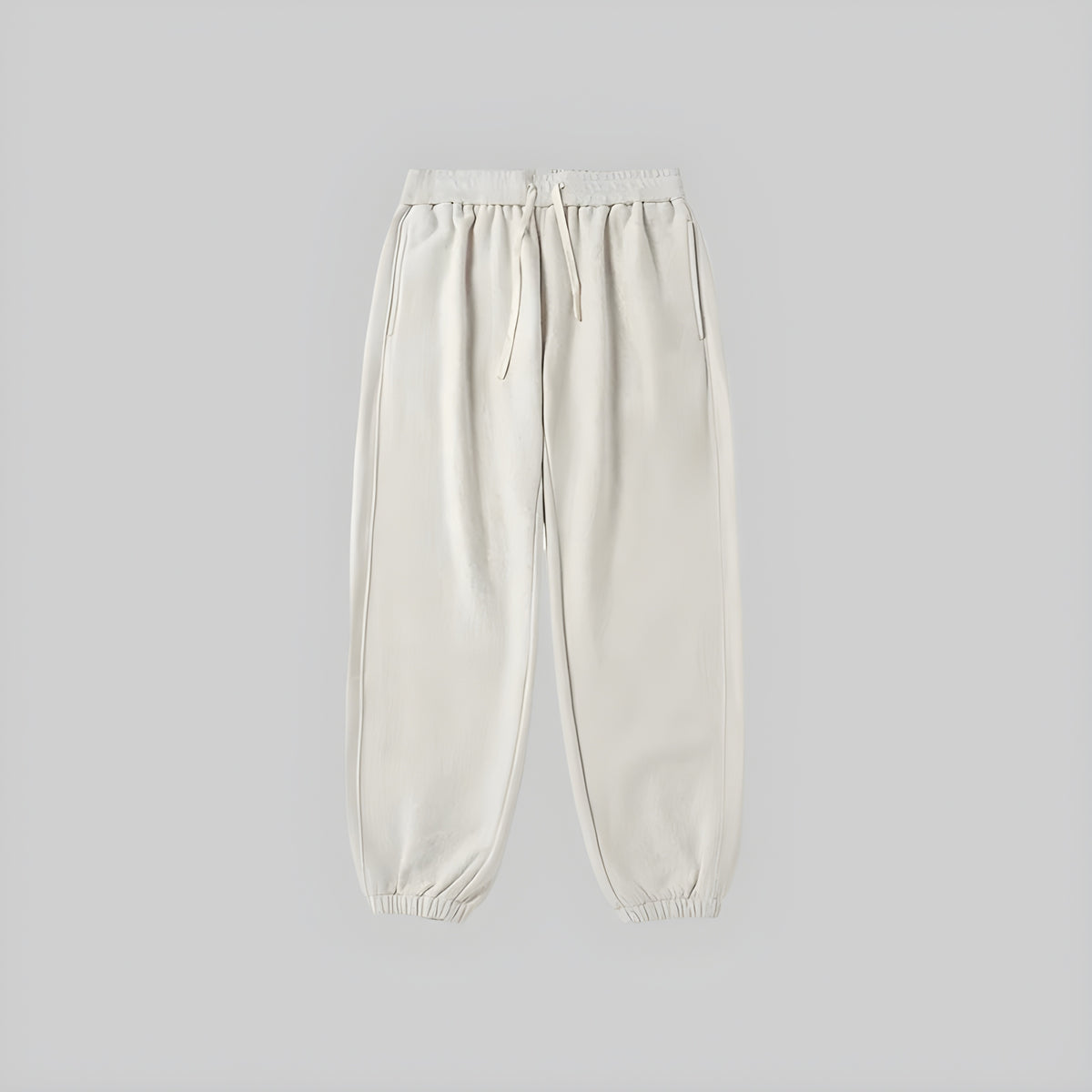 Brushed relaxed sweatpants in off-white, elastic waistband with drawstring, cuffed ankle hems