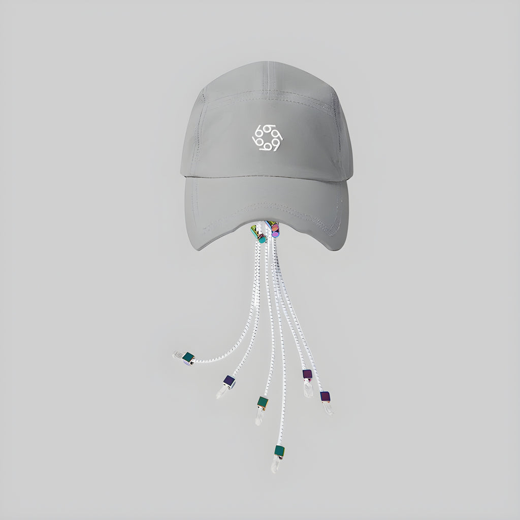Light gray photochromic cap with front logo and dangling white cords with multicolor tips
