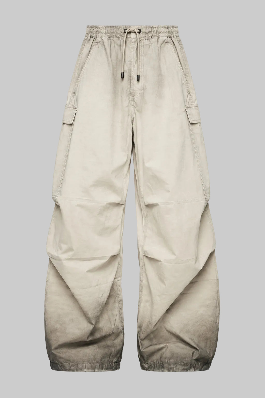 Washed utility trousers in washed khaki, drawstring waist, cargo pockets, wide leg.