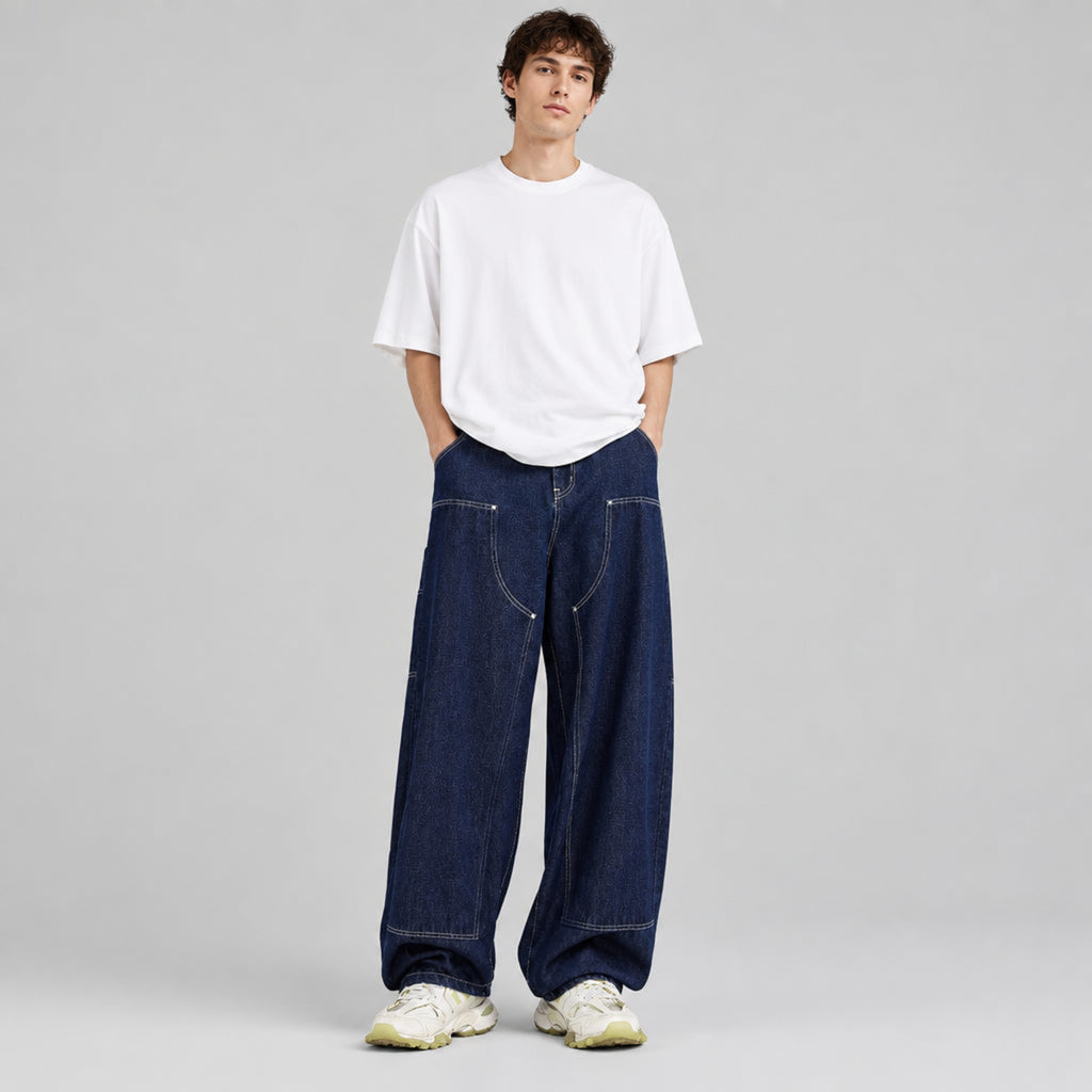 Wide-leg indigo denim jeans with contrast stitching, worn with a white tee