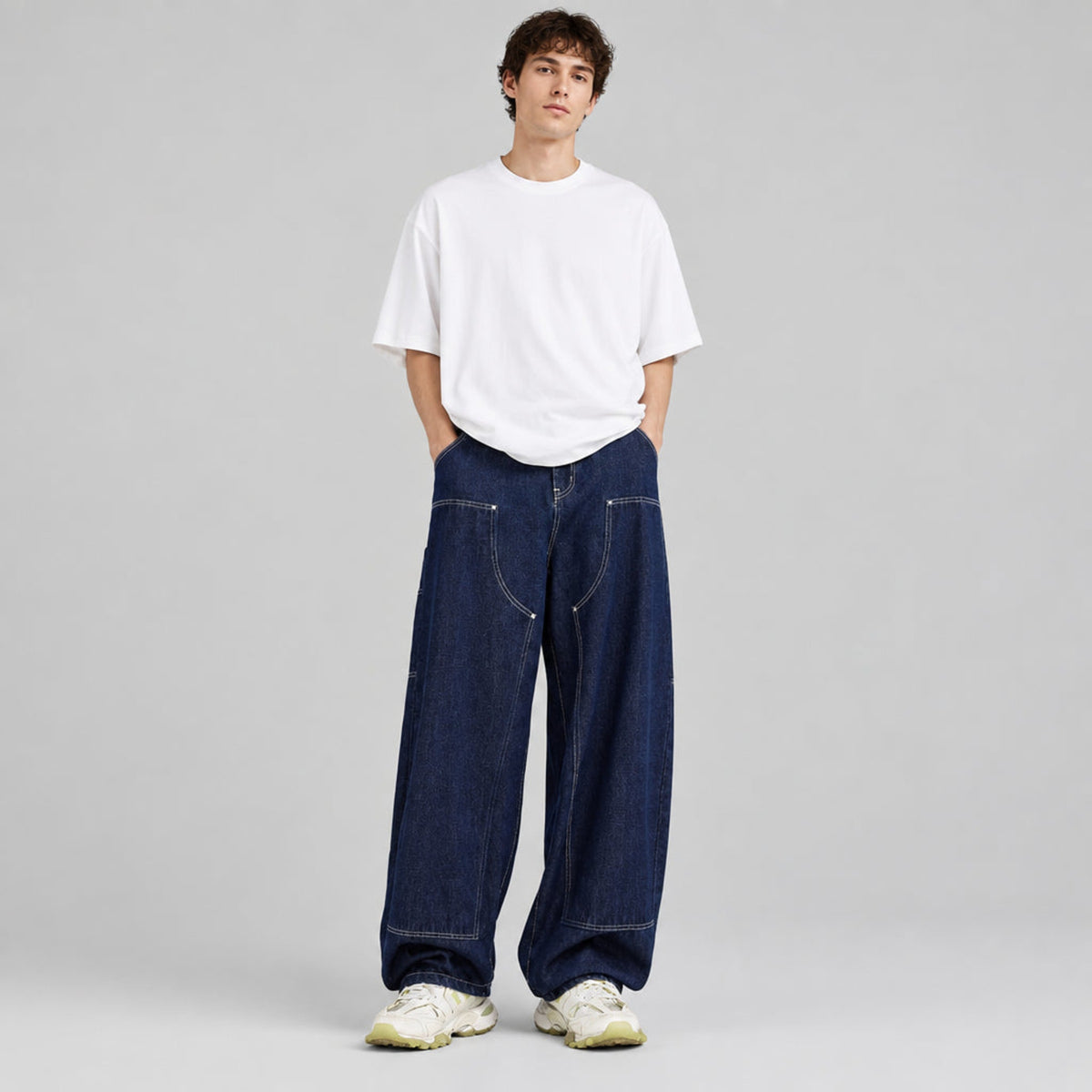 Wide-leg indigo denim jeans with contrast stitching, worn with a white tee