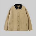Beige button-up jacket with black pointed collar and chest pocket, long sleeves