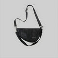 Black crescent sling bag with adjustable shoulder strap and front logo patch