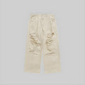 Ecru wide-leg jeans with distressed knee rips and frayed patches