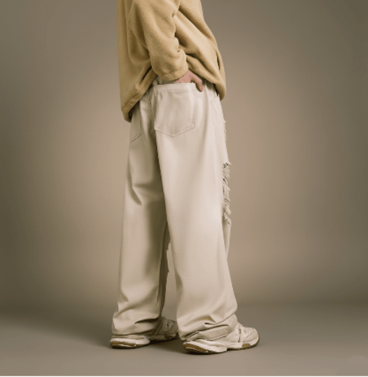 Ecru wide-leg jeans, back view with buttoned back pockets and distressed rips