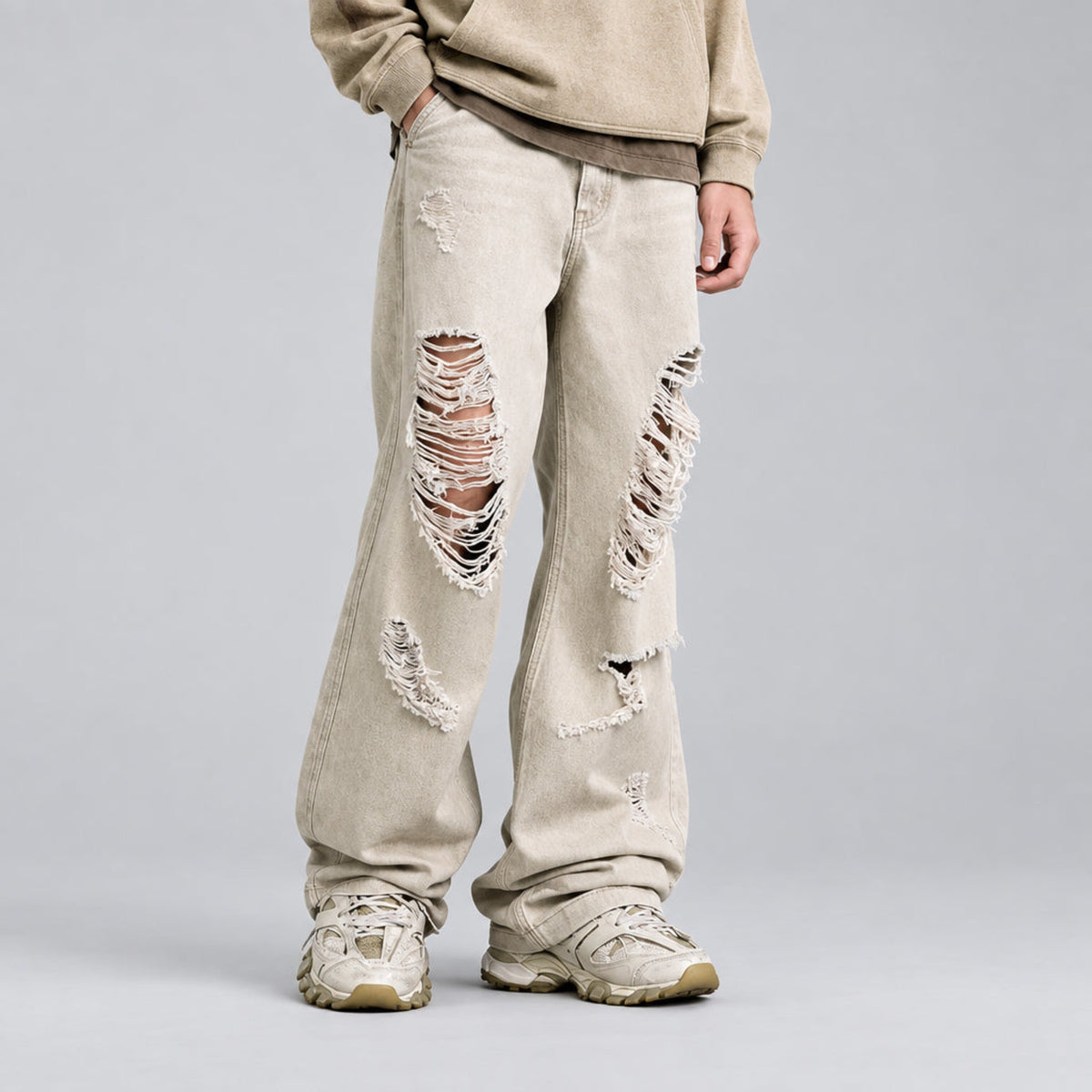 Ecru wide-leg jeans with large side thigh rips and heavy frayed detailing