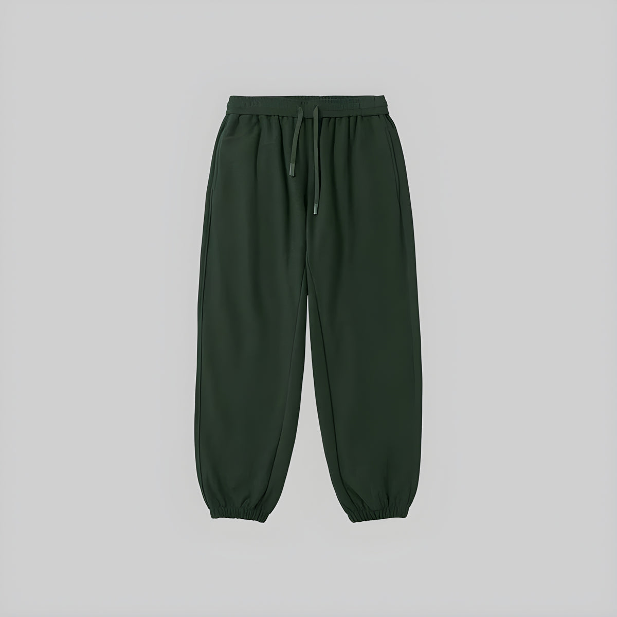 Brushed relaxed sweatpants in deep green, elastic waistband with drawstring, cuffed hems