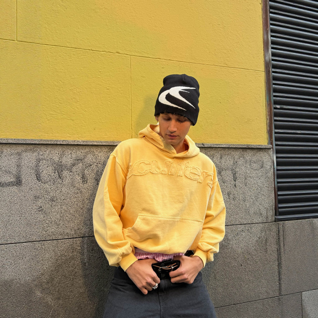 Ochre pullover hoodie featuring an embossed lettermark chest graphic and front pocket