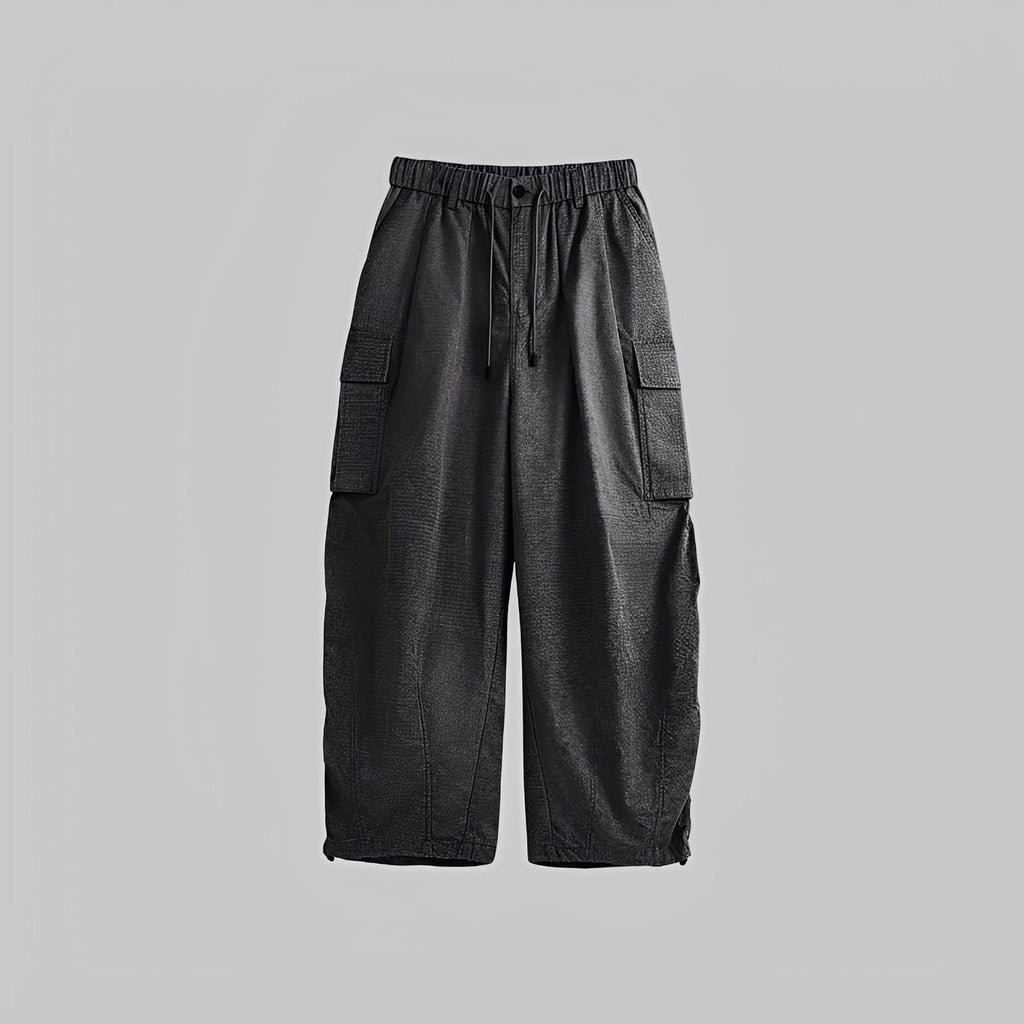 Black washed wide-leg trousers with elastic waist, drawstring, and cargo pockets