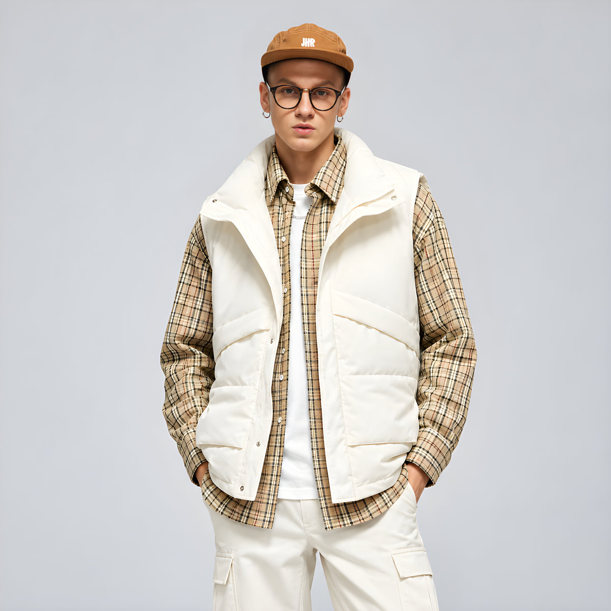 Ivory down puffer vest with stand collar, center-front zipper, worn over plaid shirt
