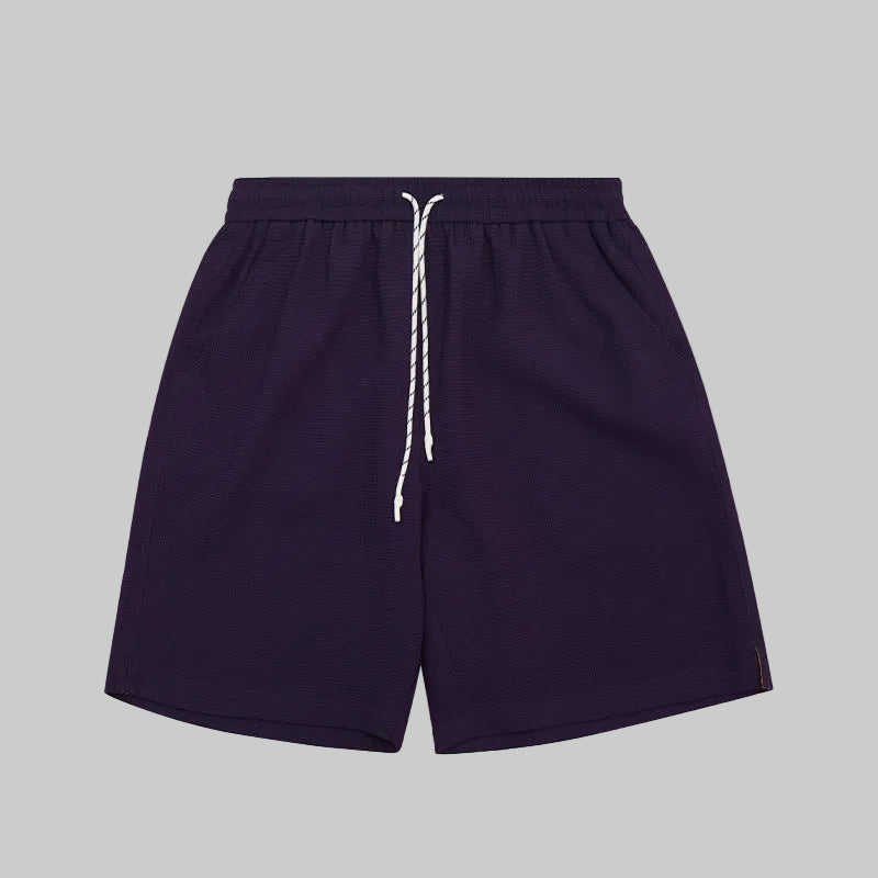 Waffle lounge shorts in violet, elastic waistband with white drawstring, relaxed fit.