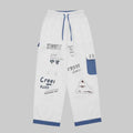 Ivory graffiti washed jeans with blue-trim cuffs and patch pockets, drawstring waist