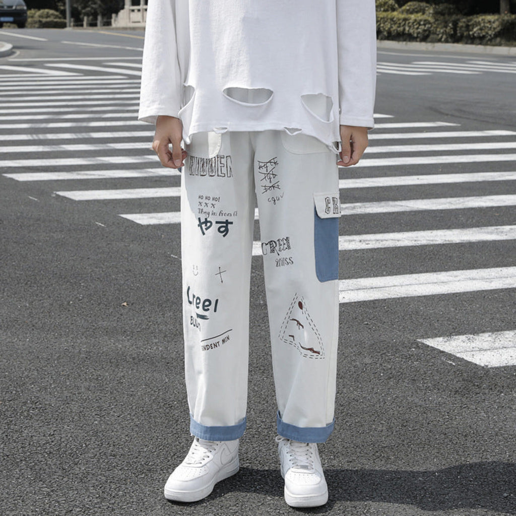 Ivory graffiti washed jeans, loose straight legs with blue cuff trim and printed blocks