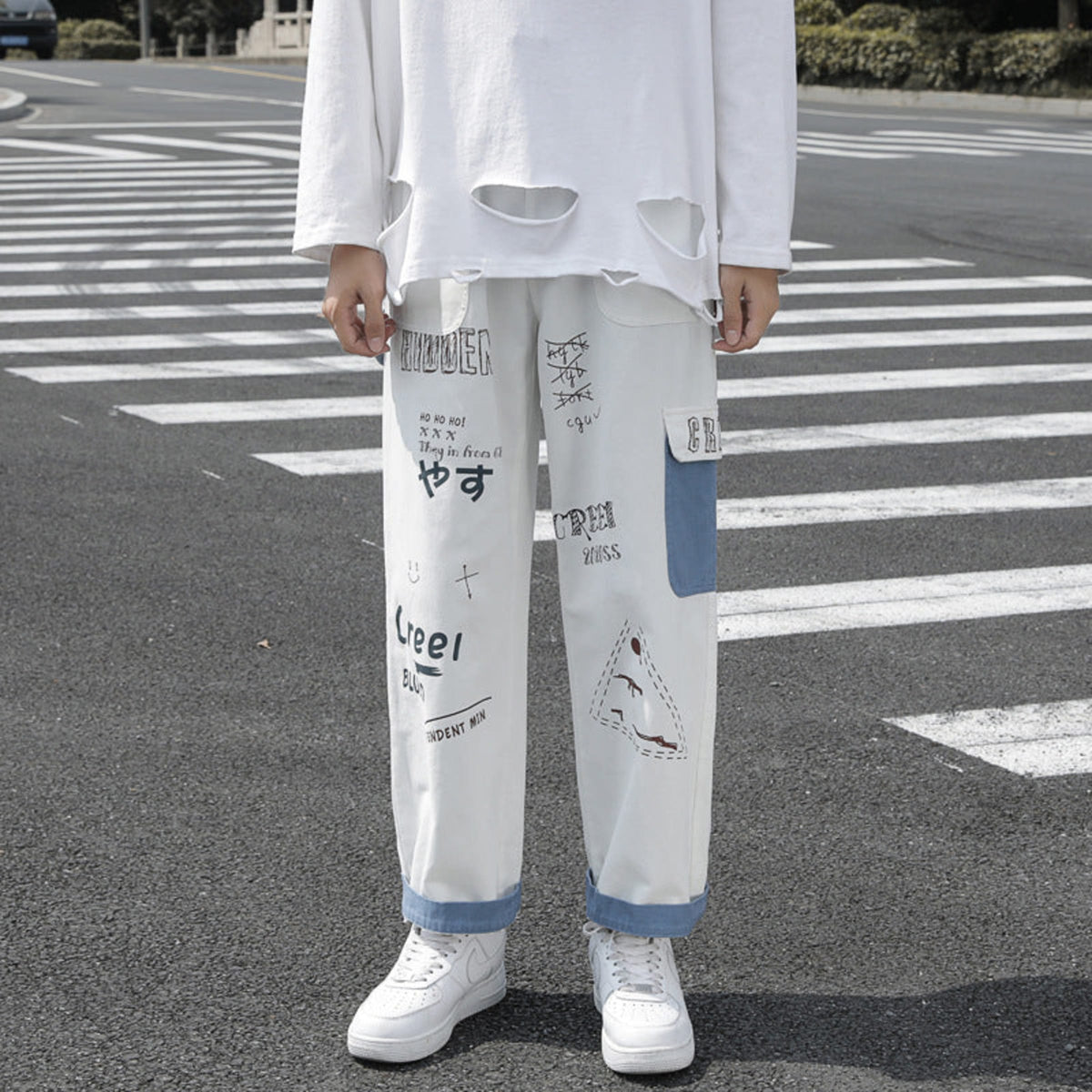 Ivory graffiti washed jeans, loose straight legs with blue cuff trim and printed blocks