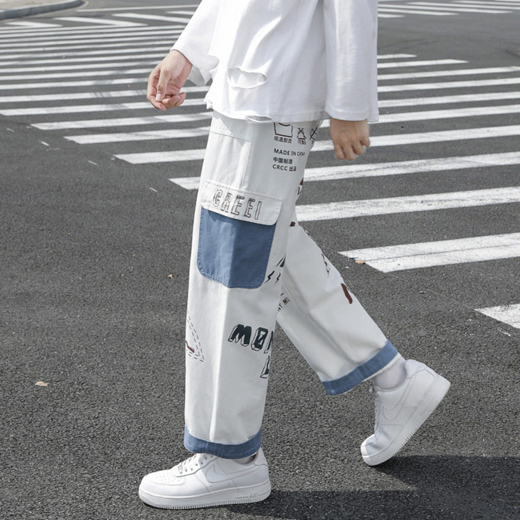 Ivory graffiti washed jeans, side view with blue-edged patch pocket and graphic text print