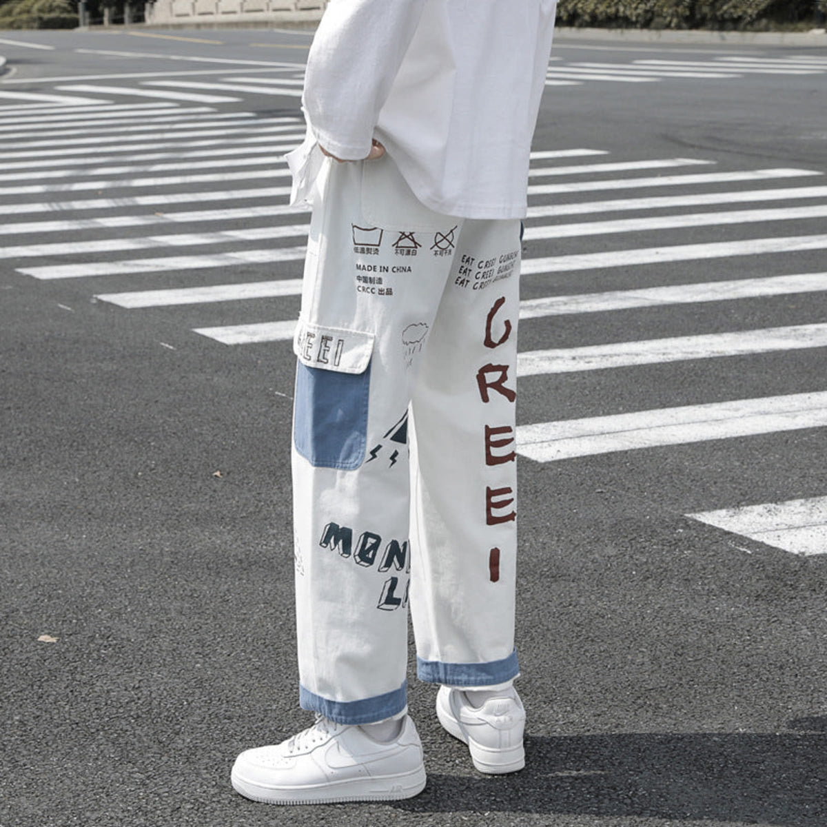 Ivory graffiti washed jeans, rear view with vertical multicolor graffiti lettering panels