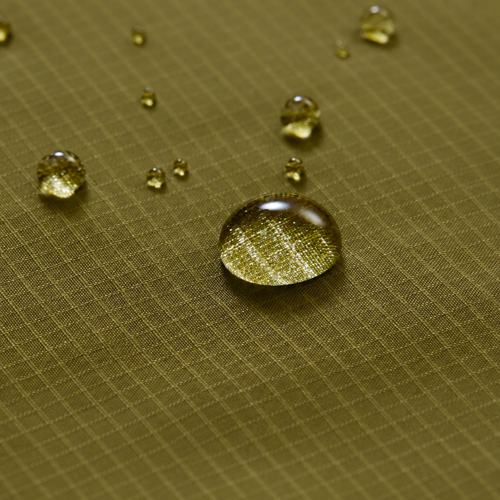 Textured quilted down jacket fabric with small water droplets