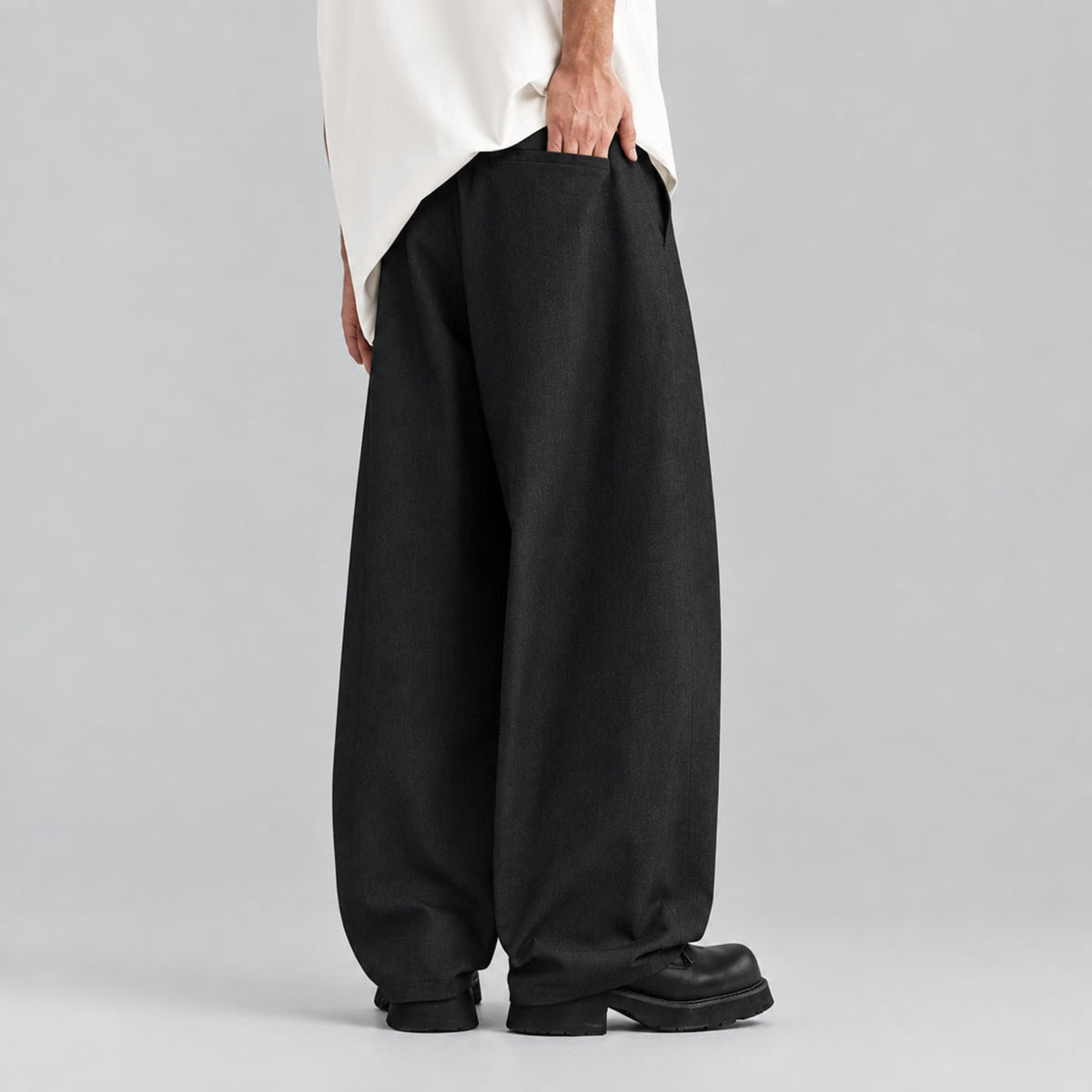 Relaxed tapered jeans with drawstring waist, dark fabric, wide leg, cuffed hem
