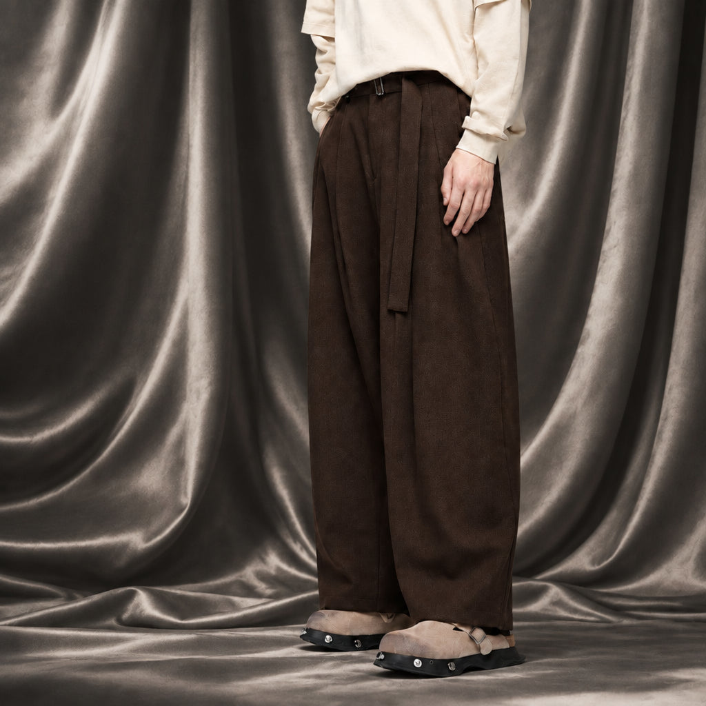Walnut wide-leg trousers with belt buckle, pleats, and side tie; wide hem
