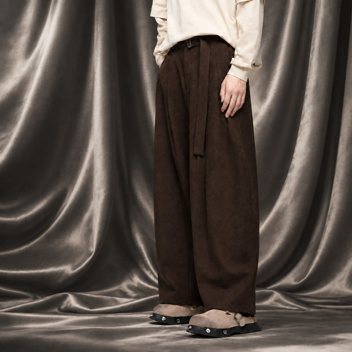 Walnut wide-leg trousers with belt buckle, pleats, and side tie; wide hem
