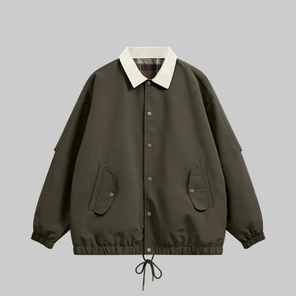 Dark utility jacket with plaid collar, button front, chest pockets, drawstring hem