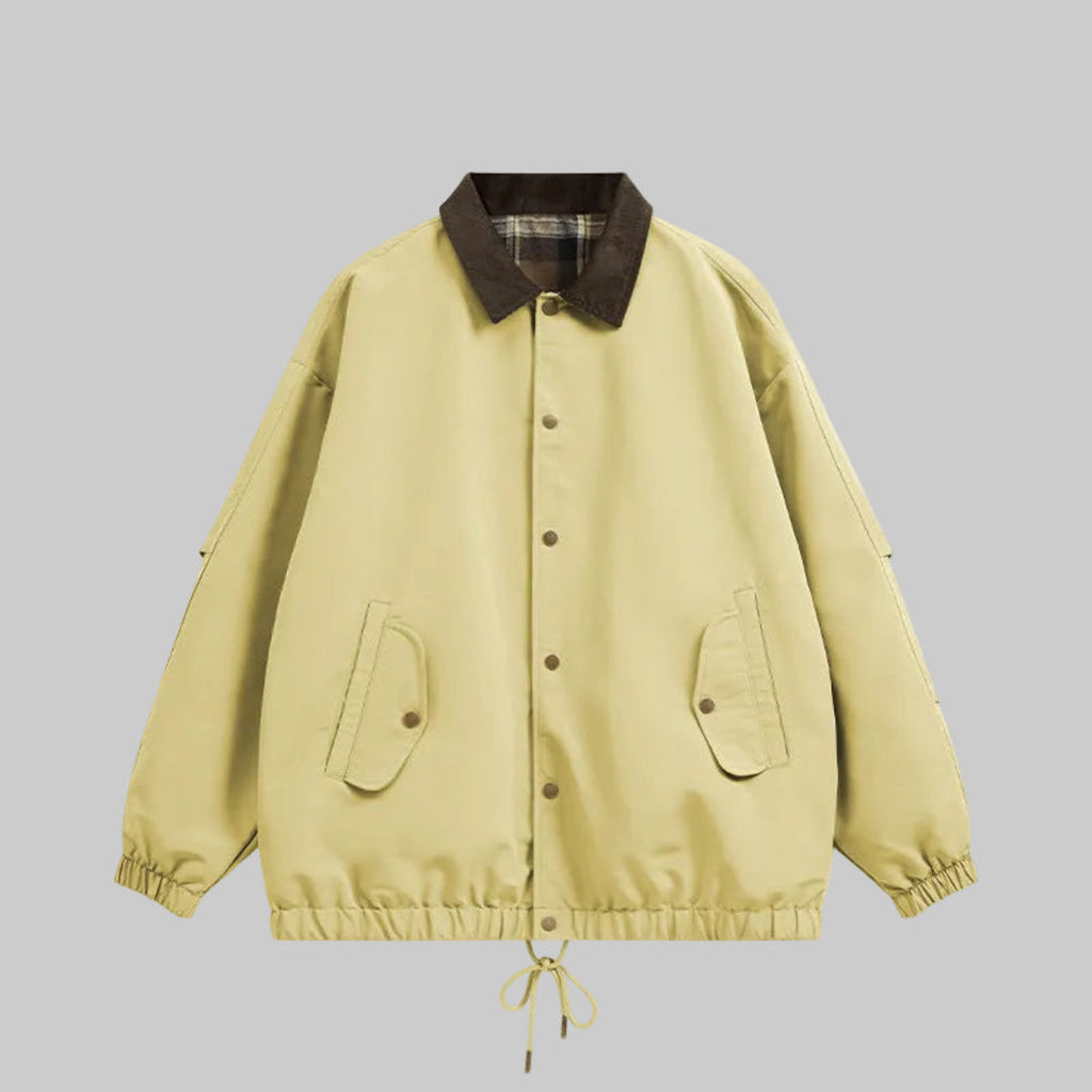 Pale yellow utility jacket with plaid collar, button front, chest pockets, drawstring hem