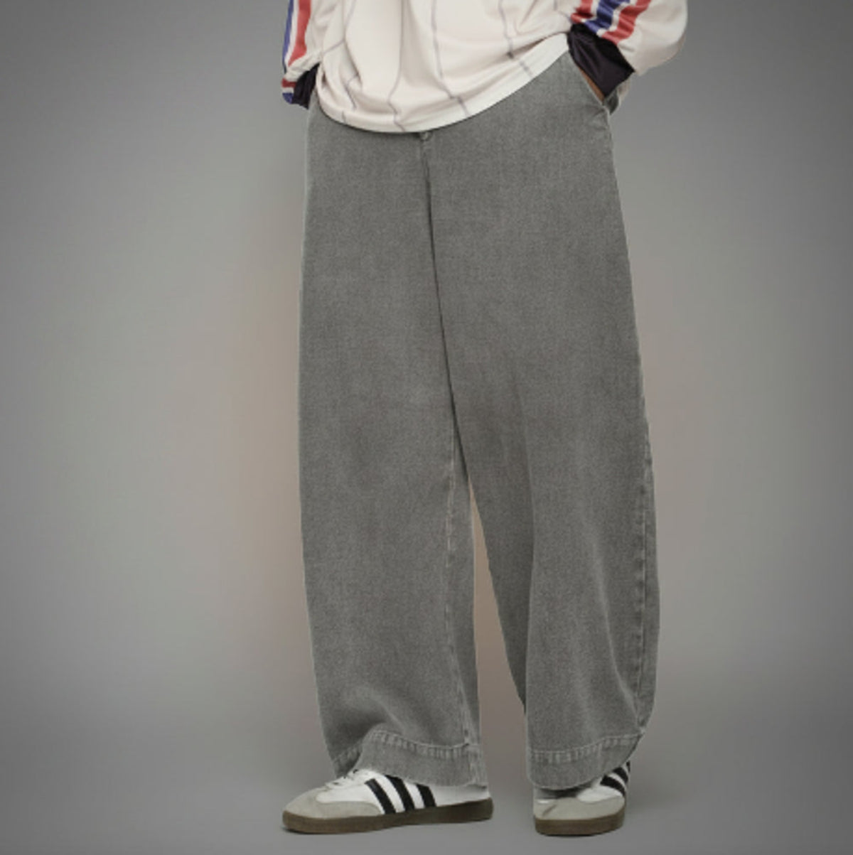 Ash washed wide-leg jeans on model, relaxed fit with cuffed hem