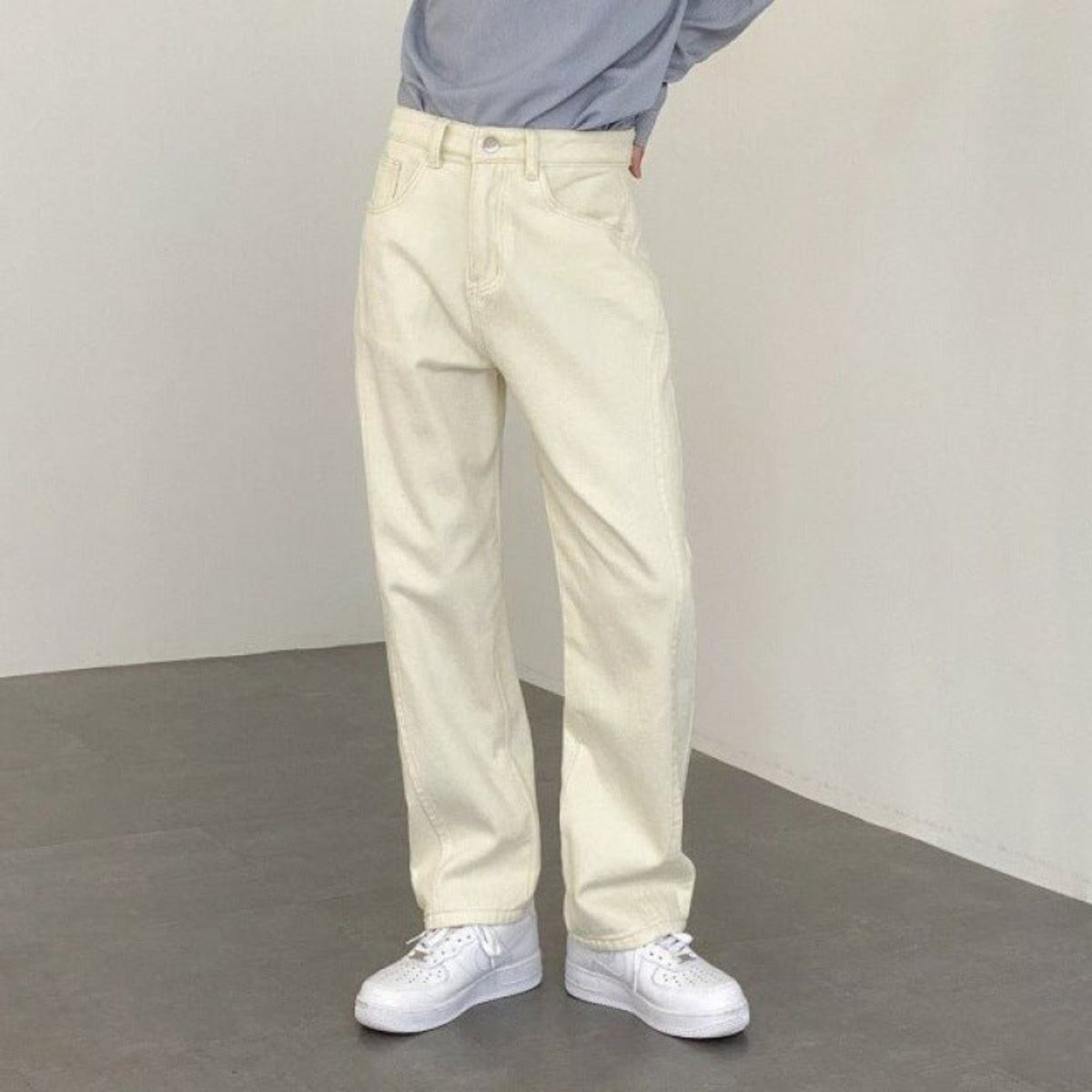 Ecru wide-leg denim trousers with front pockets and subtle faded wash